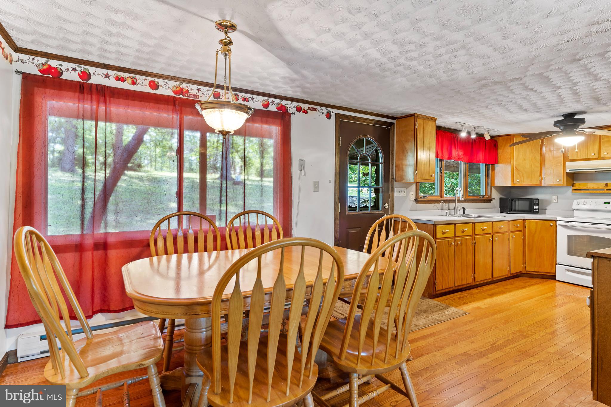 21429 Buck Trail Shade Gap, PA 17255 - Photo 8 of 42 a view of a dining room with furniture a chandelier and wooden floor