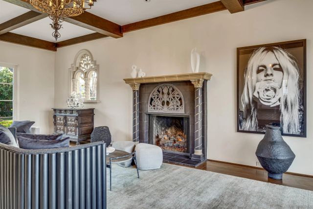 a living room with furniture a mirror and a fireplace