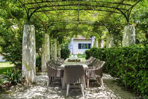 a kitchen with a table chairs refrigerator and cabinets