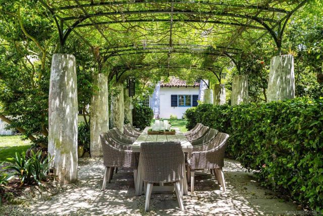 a kitchen with a table chairs refrigerator and cabinets