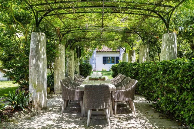 a kitchen with a table chairs refrigerator and cabinets