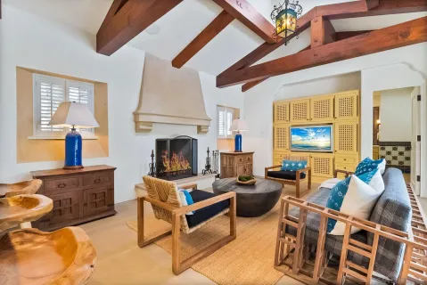 a living room with stainless steel appliances granite countertop lots of furniture and a large window