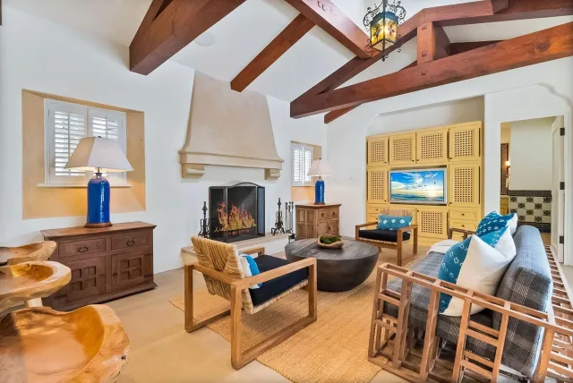 a living room with stainless steel appliances granite countertop lots of furniture and a large window