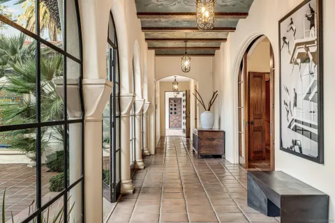 a view of a hallway with a chandelier and a mirror