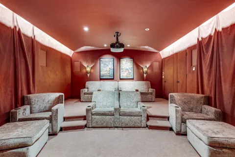 a view of a hallway with furniture and a window