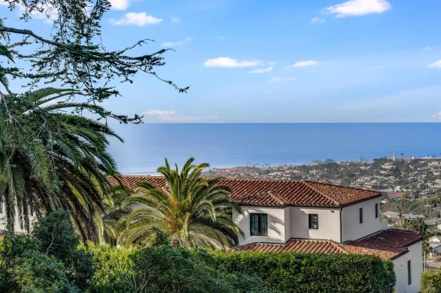 a front view of a residential apartment building with a yard