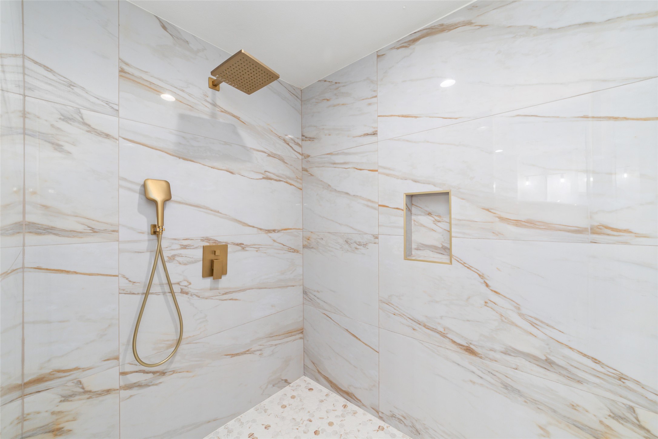 5922 Hummingbird Street Houston, TX 77096 - Photo 17 of 26 Custom tilework creates a spa-inspired walk-in shower that feels both elegant and inviting. It's one of many carefully considered updates throughout the home.