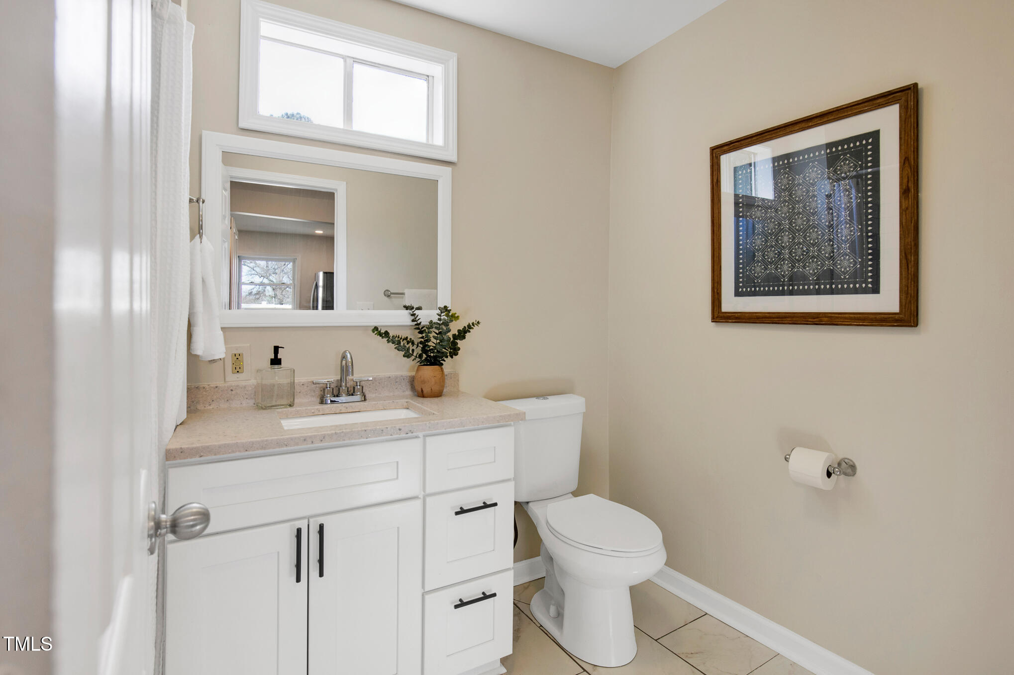302 St Augustine Raleigh, NC 27610 - Photo 18 of 27 a bathroom with a toilet a sink and mirror