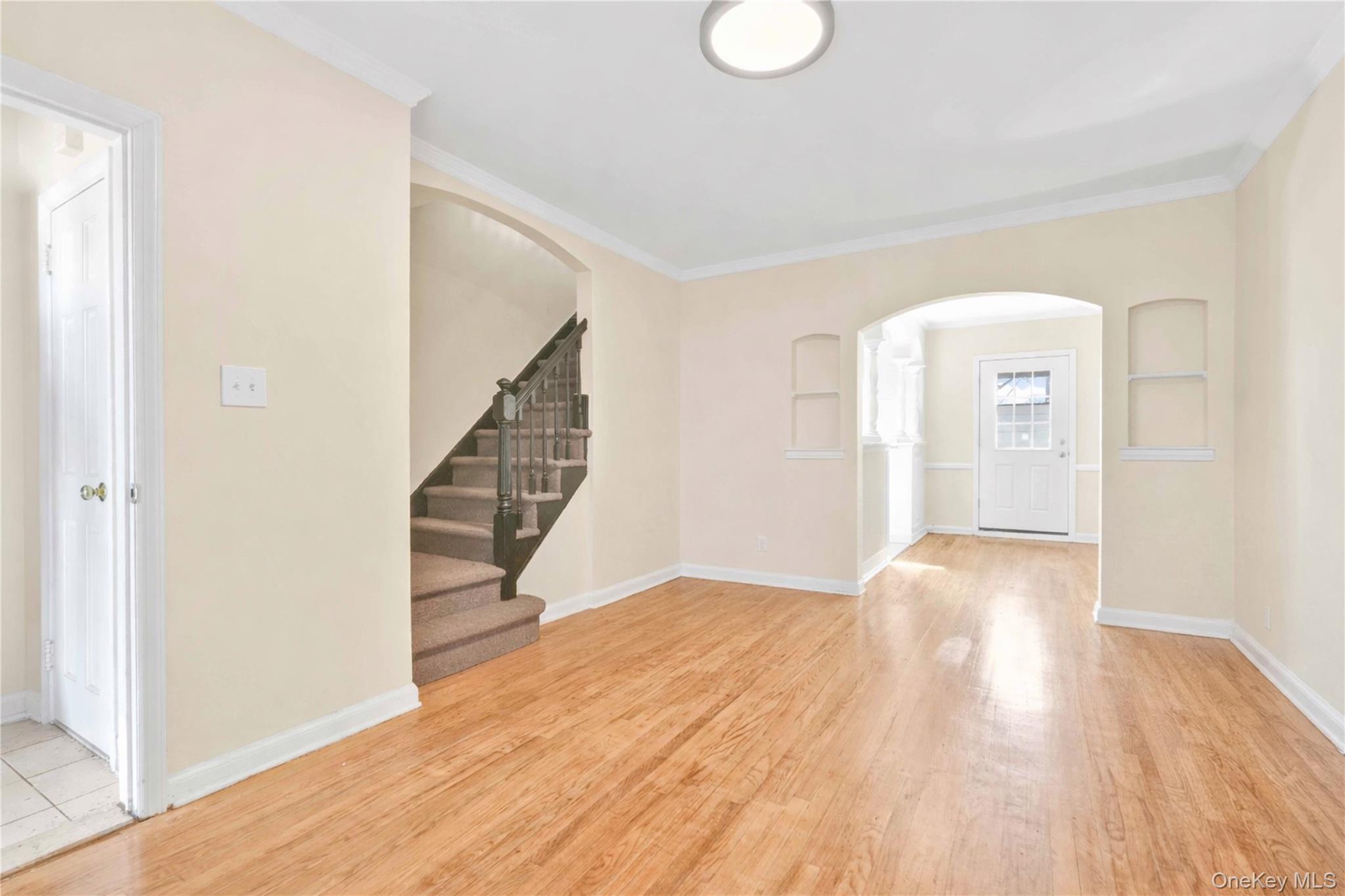136-76 71st Road Queens, NY 11367 - Photo 11 of 31 a view of empty room with wooden floor