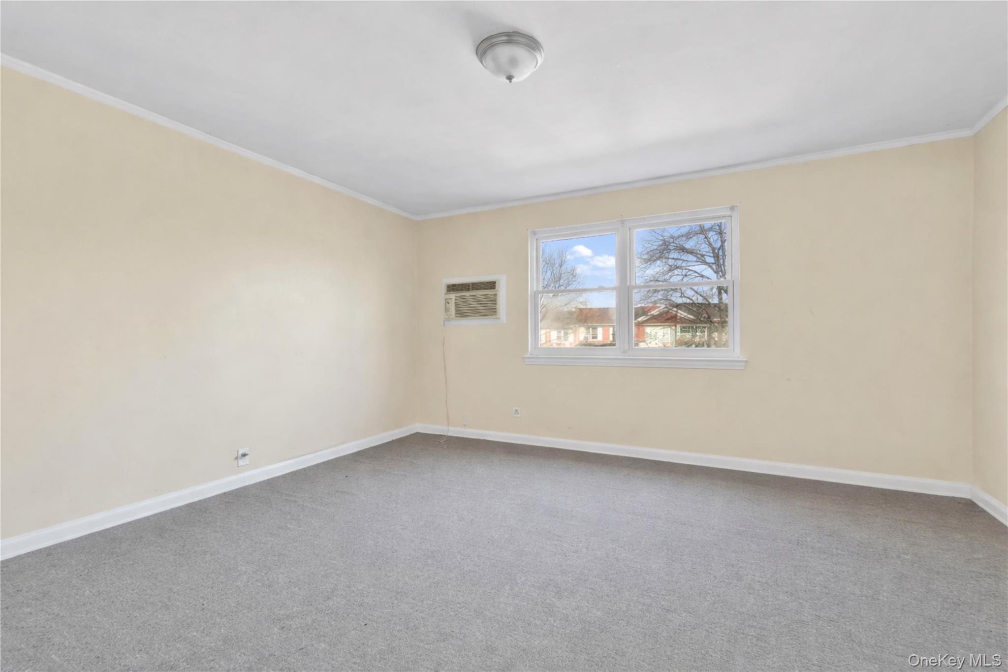 136-76 71st Road Queens, NY 11367 - Photo 14 of 31 an empty room with windows