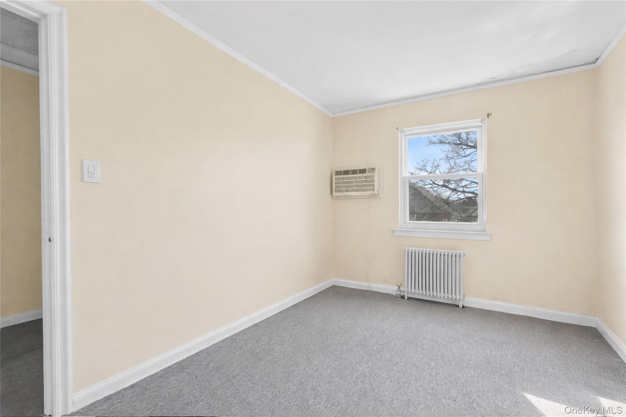 136-76 71st Road Queens, NY 11367 - Photo 17 of 31 a view of an empty room with a window