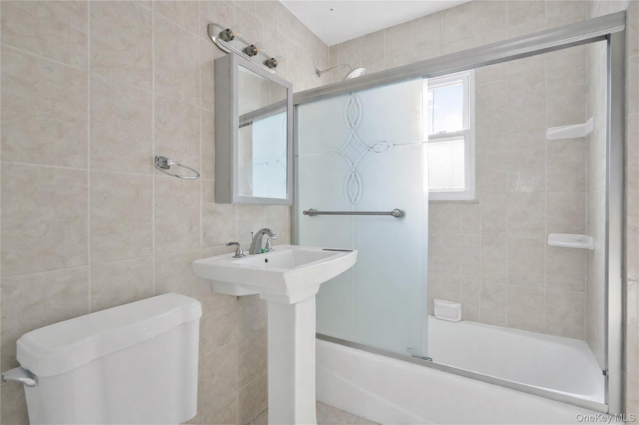 136-76 71st Road Queens, NY 11367 - Photo 18 of 31 a bathroom with a sink a toilet and shower