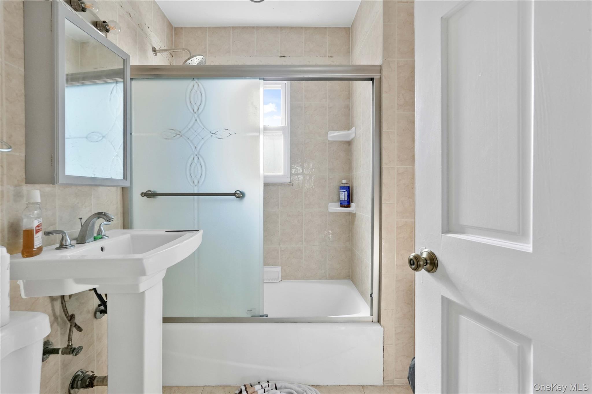 136-76 71st Road Queens, NY 11367 - Photo 19 of 31 a bathroom with a sink and a mirror