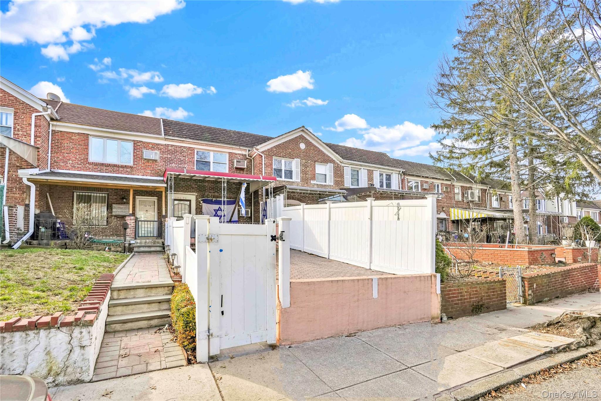 136-76 71st Road Queens, NY 11367 - Photo 2 of 31 a view of a white building with a fountain in front of it