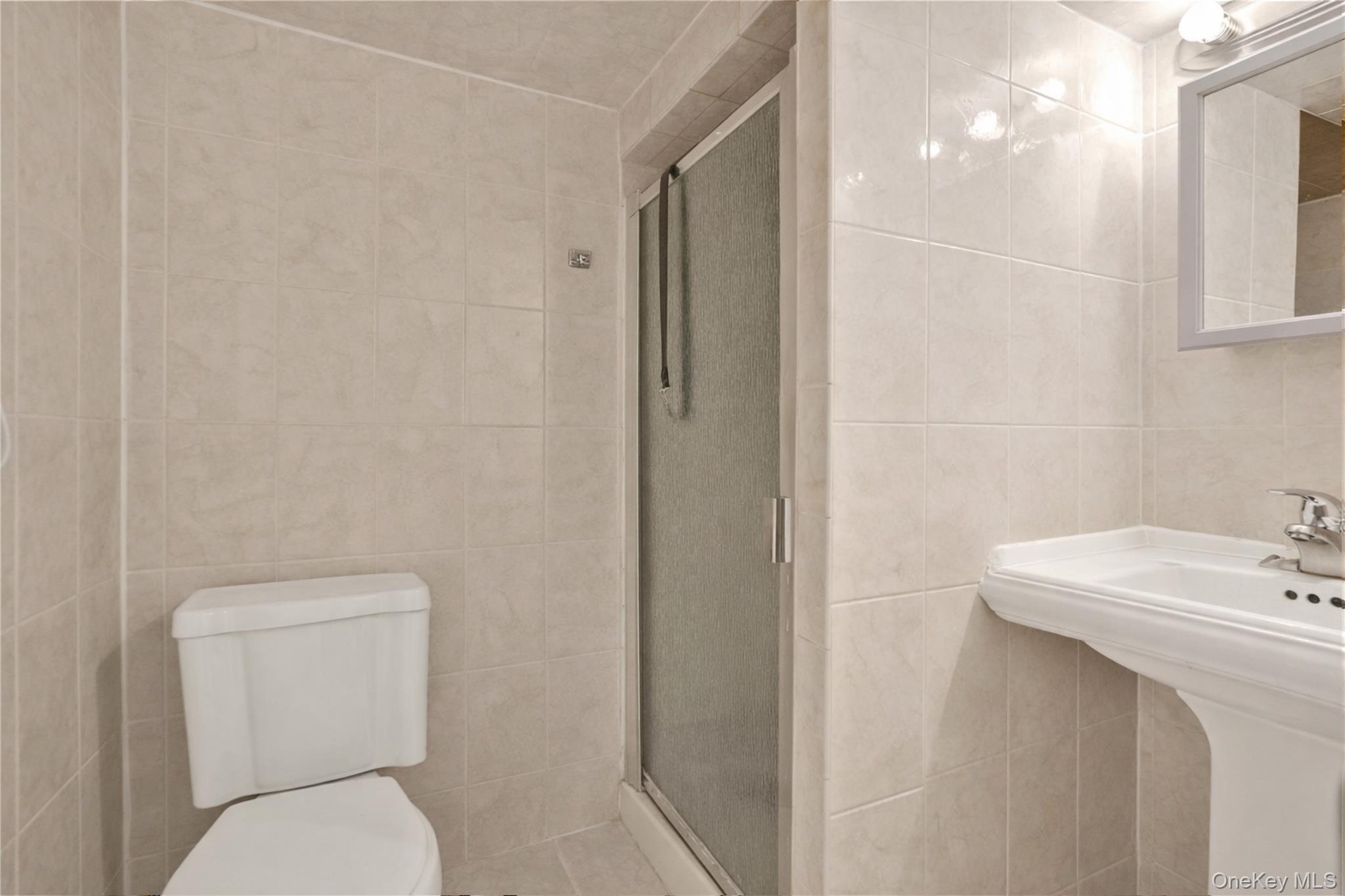 136-76 71st Road Queens, NY 11367 - Photo 24 of 31 a white toilet sitting next to a bathroom sink