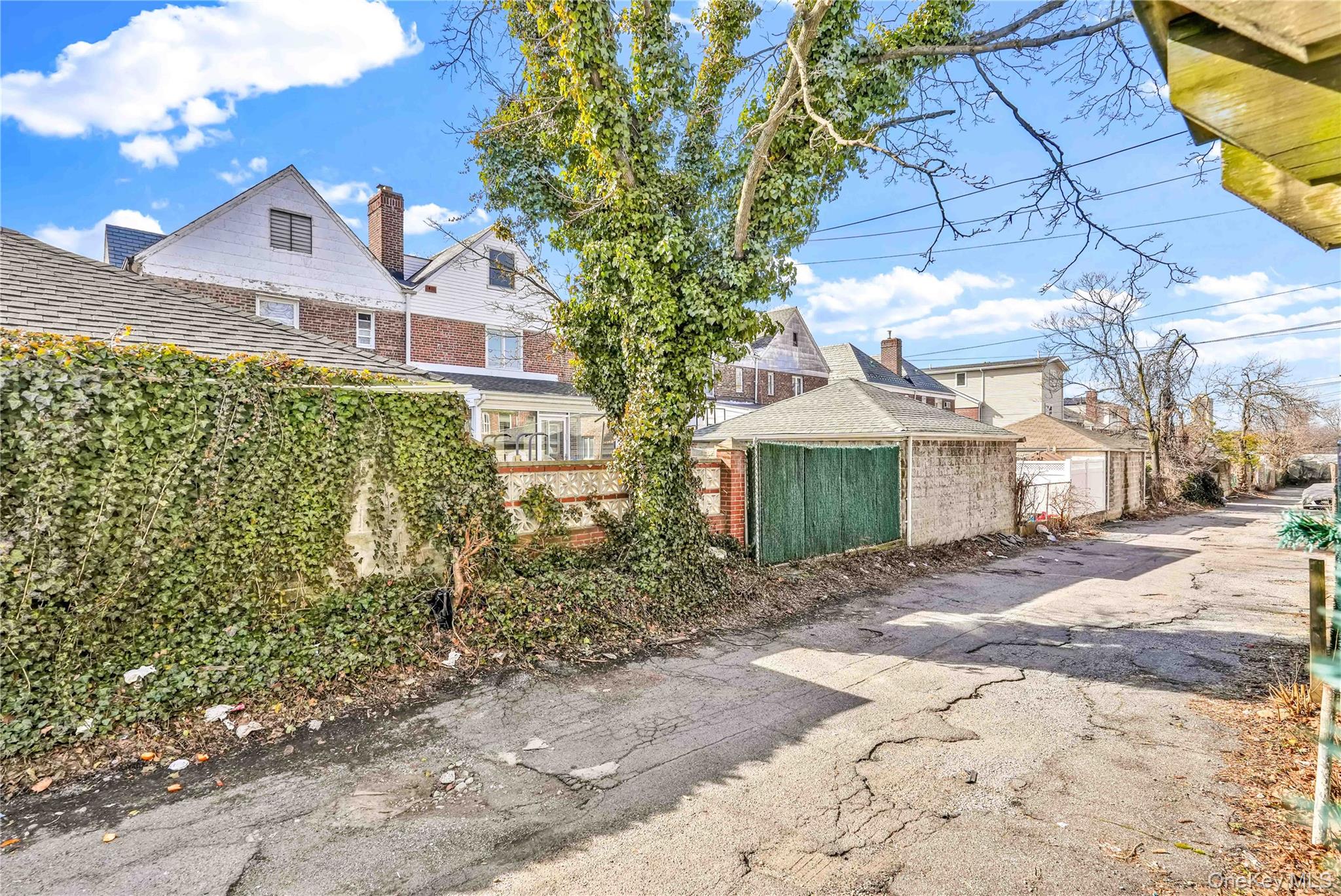 136-76 71st Road Queens, NY 11367 - Photo 29 of 31 a front view of a house with a yard and garage