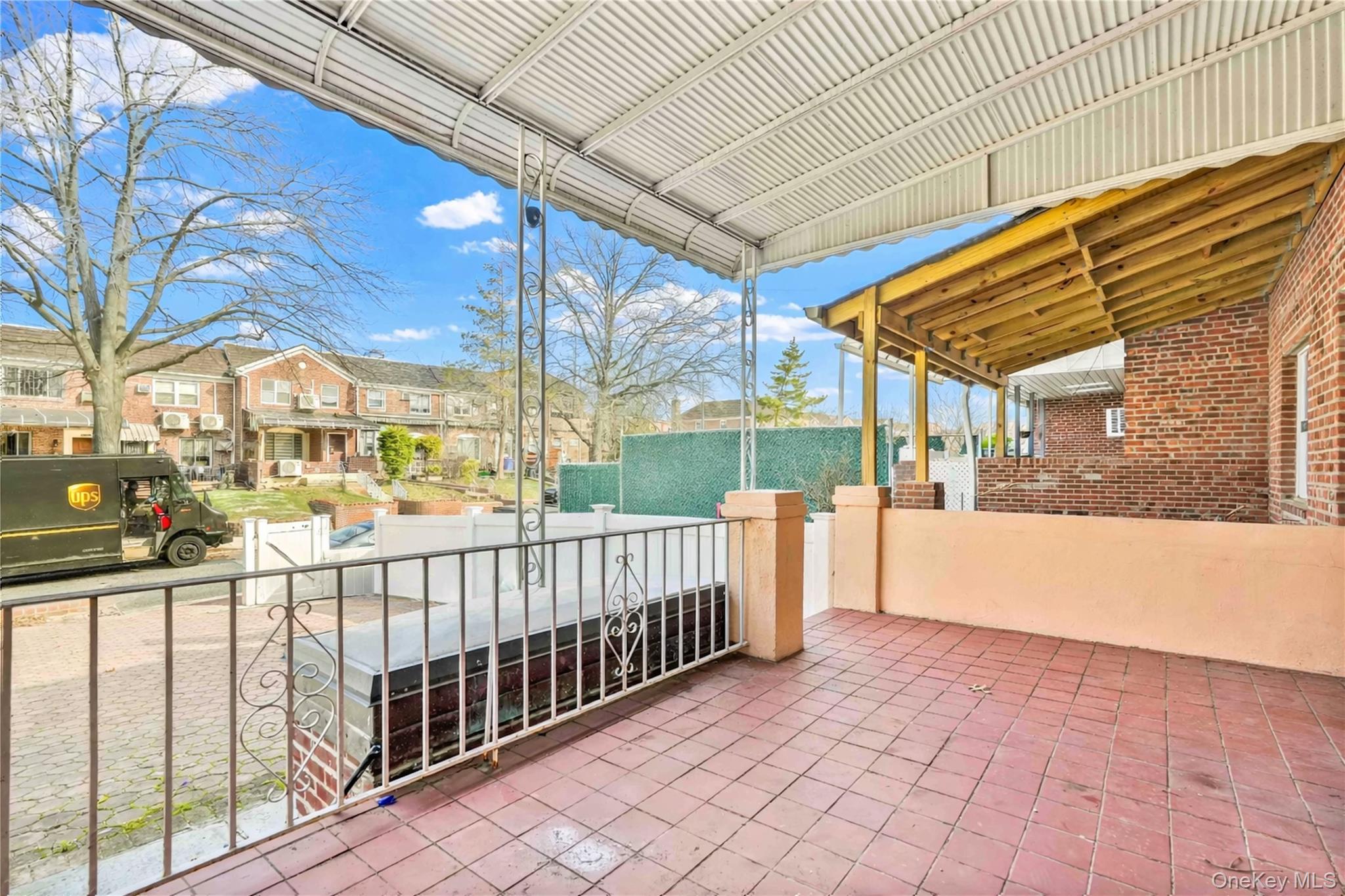 136-76 71st Road Queens, NY 11367 - Photo 4 of 31 a view of a porch with wooden fence