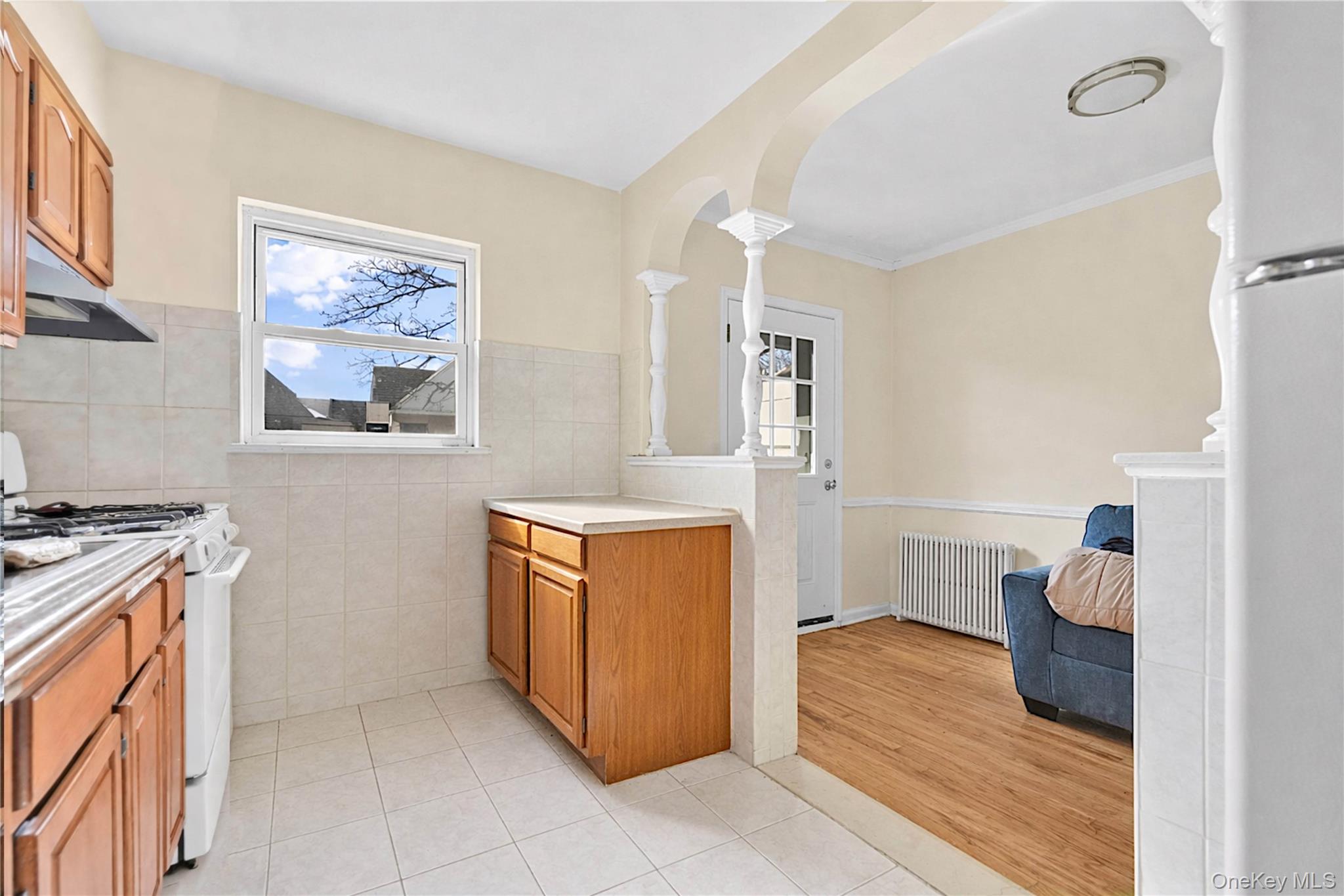 136-76 71st Road Queens, NY 11367 - Photo 7 of 31 a kitchen with stainless steel appliances granite countertop a stove and a refrigerator