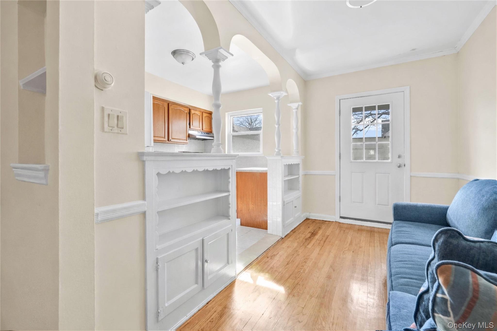 136-76 71st Road Queens, NY 11367 - Photo 10 of 31 a bedroom with a bed and a chandelier