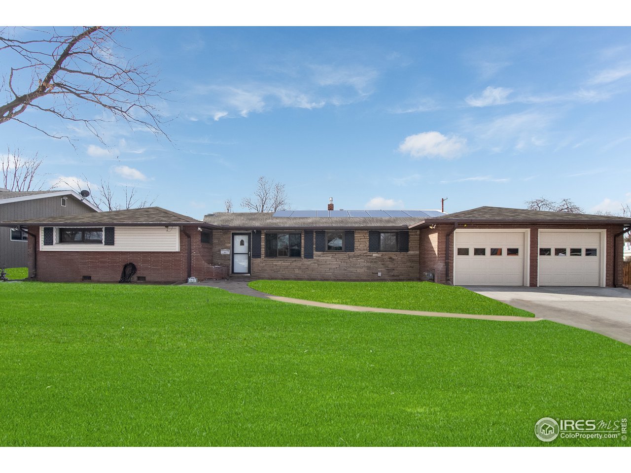 4605 Reed Street Wheat Ridge, CO 80033 - Photo 3 of 25 a view of a big house with a big yard and large trees