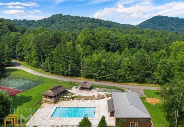 a view of a chair and table in backyard of the house
