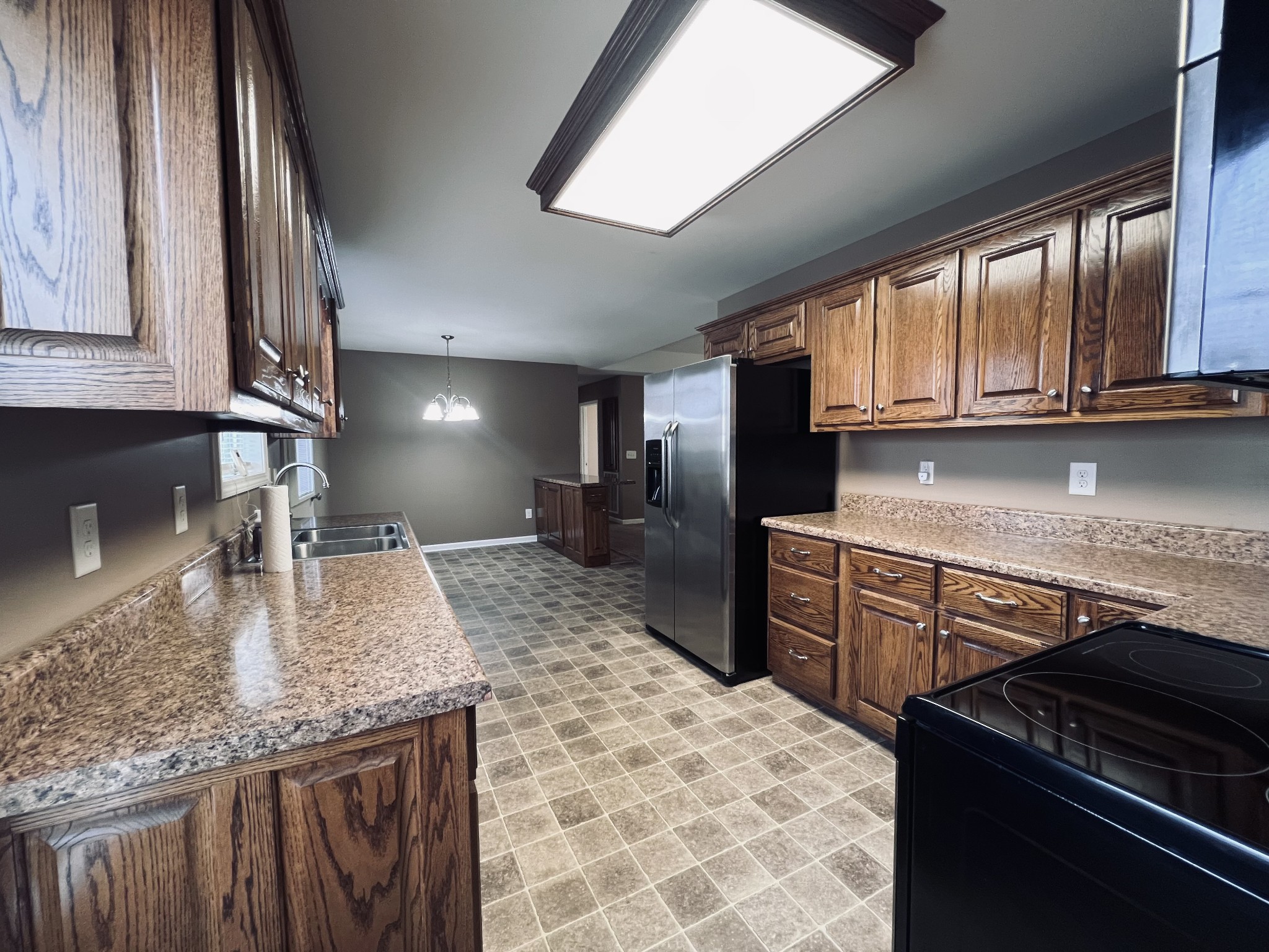 8659 Dog Branch Road Mount Pleasant, TN 38474 - Photo 21 of 44 a kitchen with kitchen island granite countertop a sink stove and cabinets