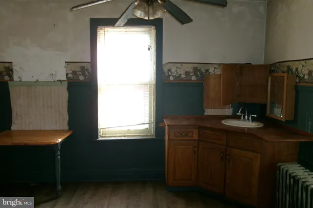 a kitchen with a sink cabinets and a window