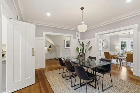 a view of a dining room with furniture wooden floor and chandelier