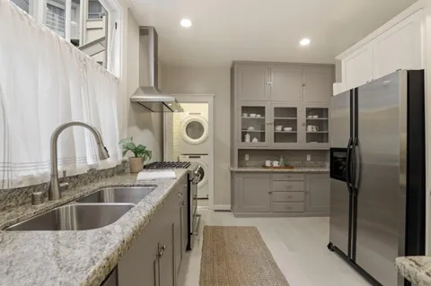 a kitchen with refrigerator and cabinets