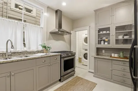 a kitchen with stainless steel appliances granite countertop a sink and cabinets
