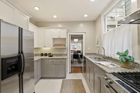 a kitchen with stainless steel appliances granite countertop a stove a sink dishwasher a refrigerator and a oven