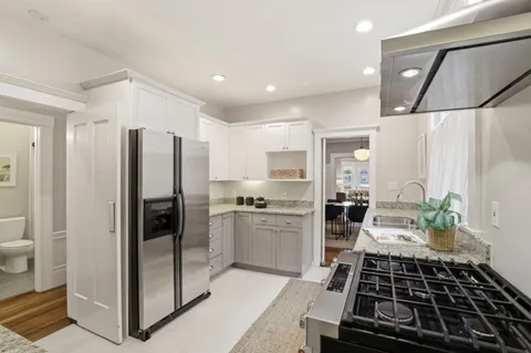 a kitchen with a refrigerator and a stove