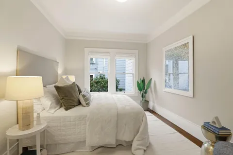 a bedroom with a bed and a lamp