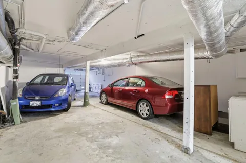 a view of parking garage with cars parked