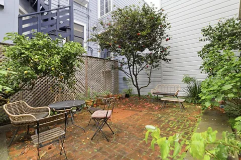 a view of a backyard with chairs