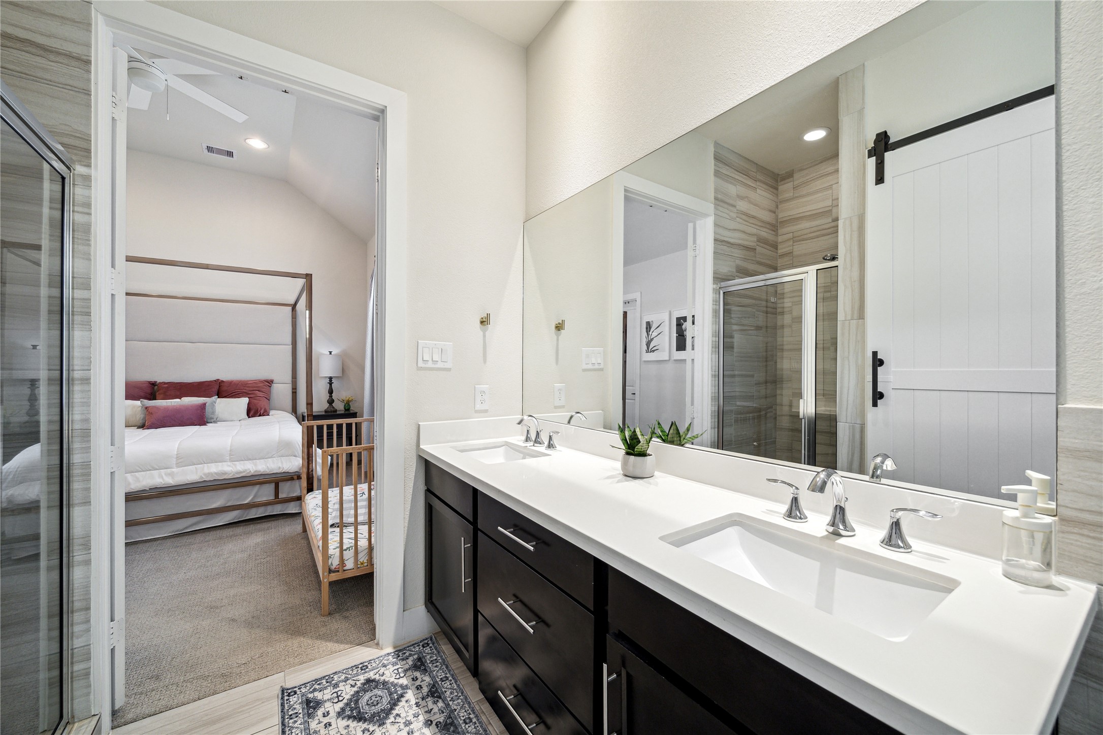 3939 Tulane Street Houston, TX 77018 - Photo 12 of 23 a en suite bathroom with a double vanity sink a mirror and shower