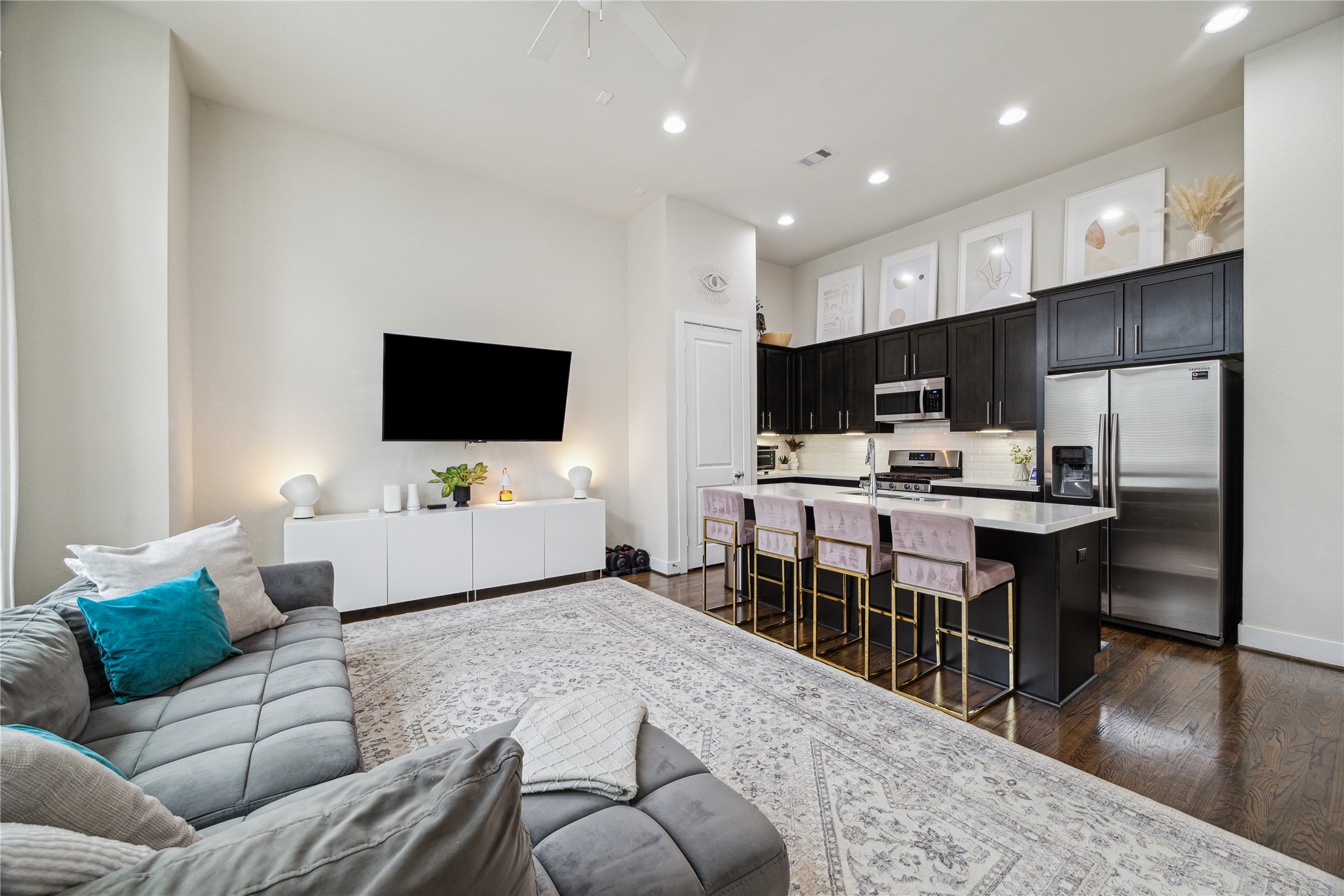 3939 Tulane Street Houston, TX 77018 - Photo 8 of 23 a living room with furniture kitchen view and a flat screen tv