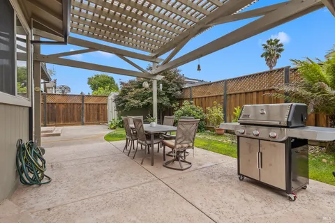 a view of a patio with a table and chairs