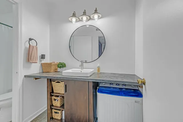 a white toilet sitting next to a shower curtain