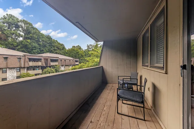 a view of a garden with large trees
