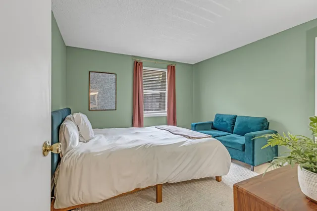 a bedroom with bed and a couch