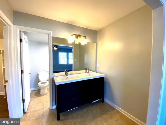 a room with a sink and a mirror