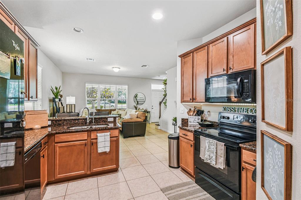 10624 Reams Road Windermere, FL 34786 - Photo 13 of 61 a kitchen with stainless steel appliances a stove sink and microwave