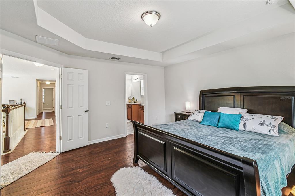 10624 Reams Road Windermere, FL 34786 - Photo 22 of 61 a bedroom with a bed and wooden floor