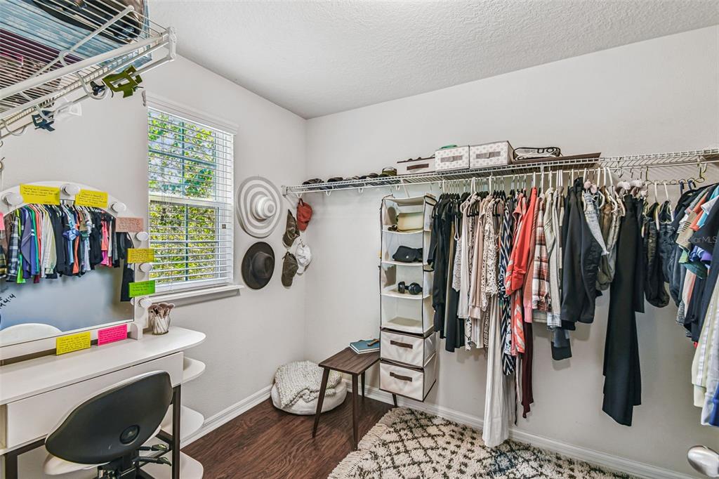 10624 Reams Road Windermere, FL 34786 - Photo 24 of 61 a view of walk in closet with clothes and shoes