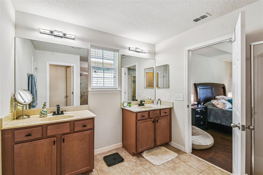10624 Reams Road Windermere, FL 34786 - Photo 27 of 61 a bathroom with a toilet a sink and mirror