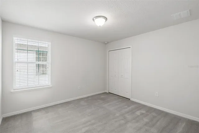 a white toilet sitting next to a shower
