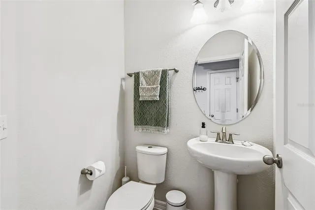 a view of a porch with a table chairs and a yard