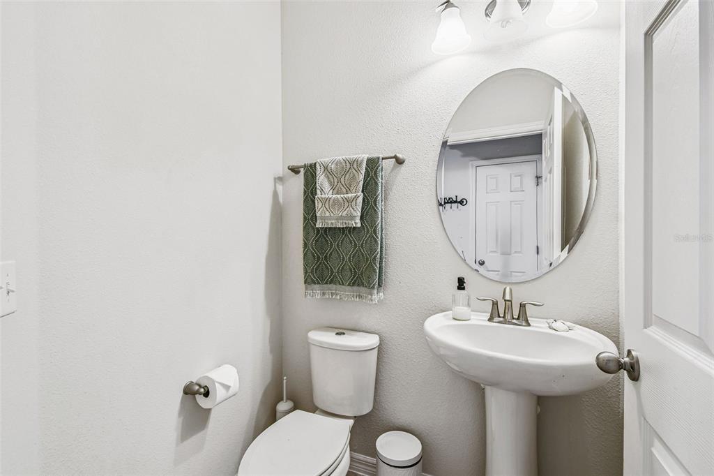10624 Reams Road Windermere, FL 34786 - Photo 38 of 61 a bathroom with a toilet sink and mirror