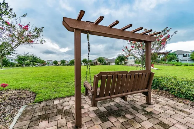 a view of yard with swimming pool and green space